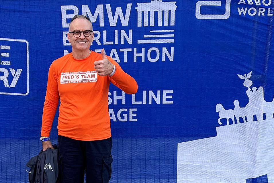 Craig Nolan, MD, holds up his Fred’s Team hat after completing the Paris Marathon 